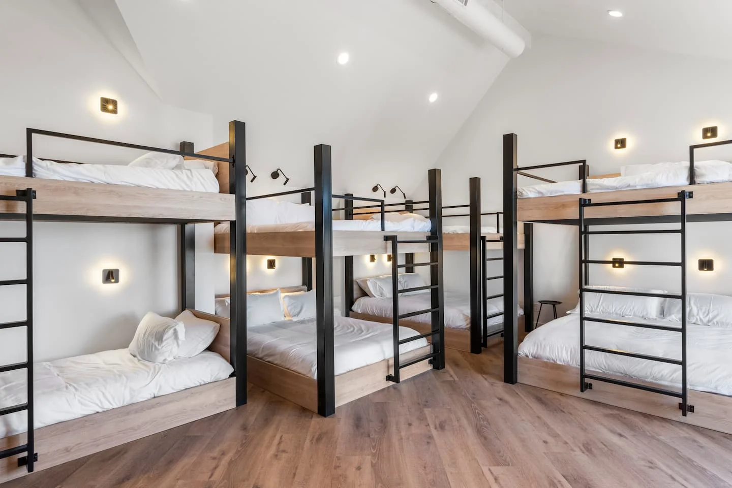 Bright bunk suite with wood bed frames and white bedding